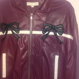 burgundy faux-leather jacket with black bow accents